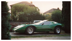 Green Nova kit car beside a hedge, side view